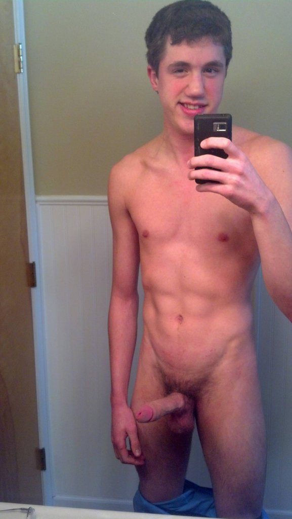 Teen taking nude selfie in the mirror with his cock out